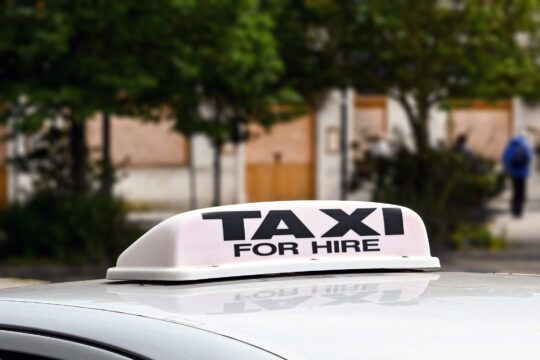 Close up view of the sign on the roof of a taxi isolated against a blurred background. No people, Copy space.