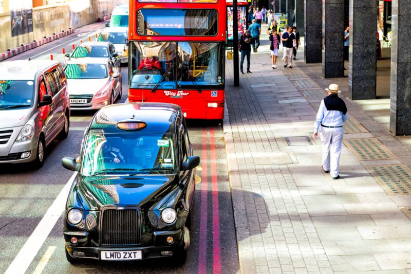 Above street view with black taxi cab vehicle in traffic jam at Waterloo train station with people