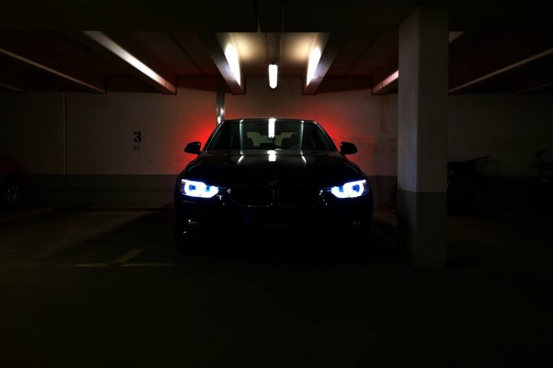 bmw in dark car park with LED lights